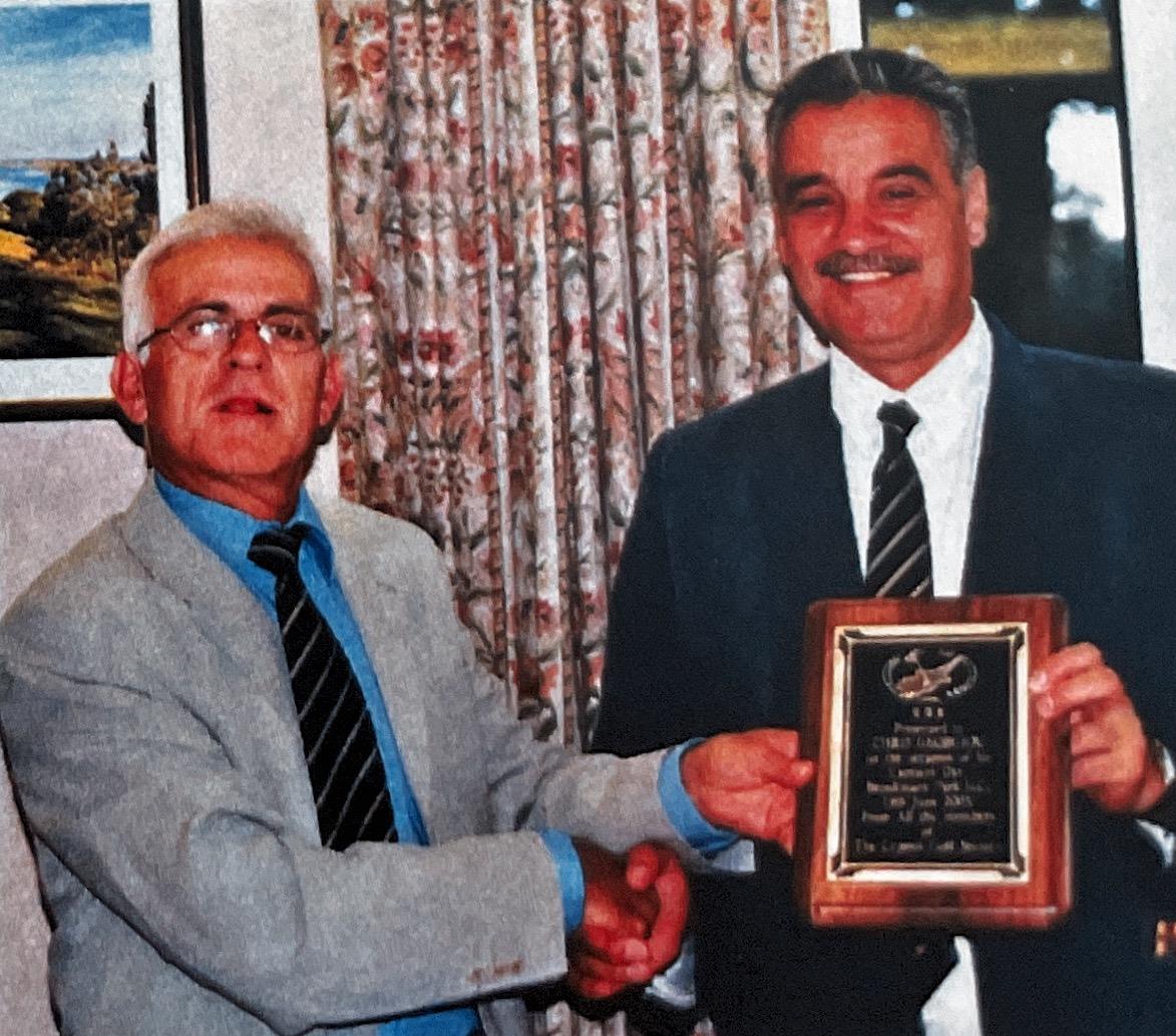 The President presenting The Captain with his momento